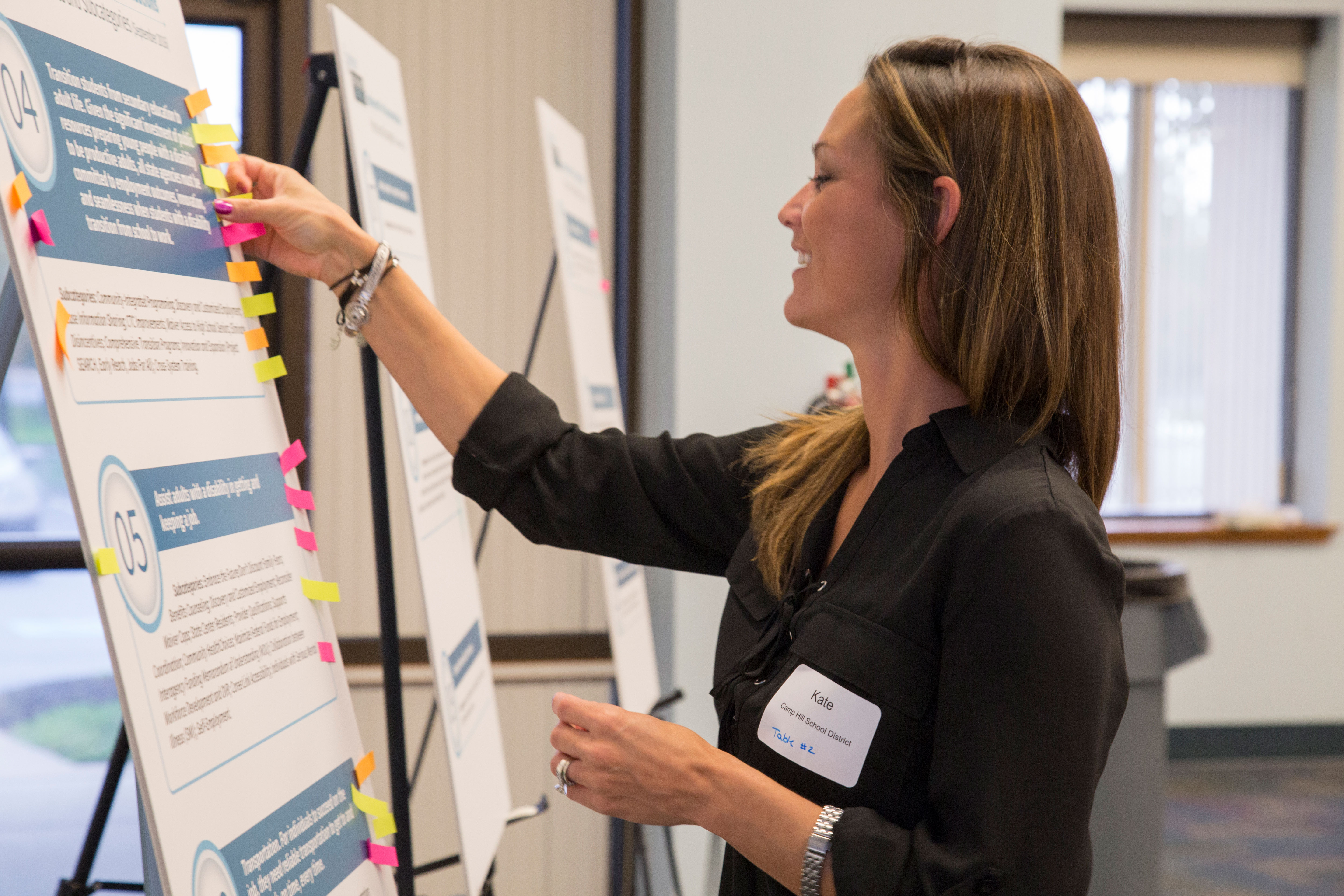 Conference participant casting her vote on a poster