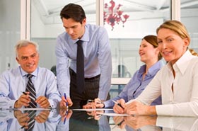 Image of several business people in a board meeting