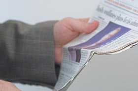 person holding a newspaper