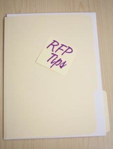 manilla file folder with "RFP tips" sticky note applied